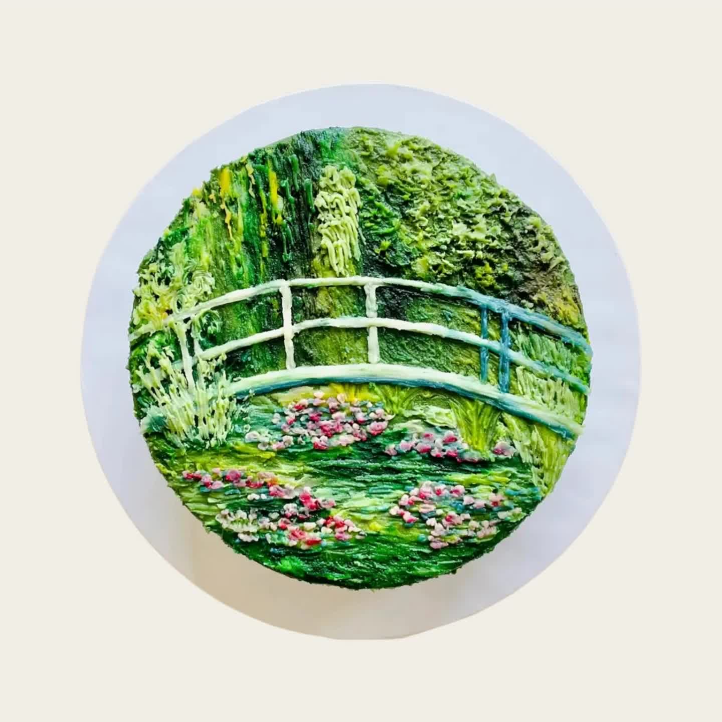 A Fig & Owl Canvas cake hand-painted with Monet's water-garden bridge in green buttercream
